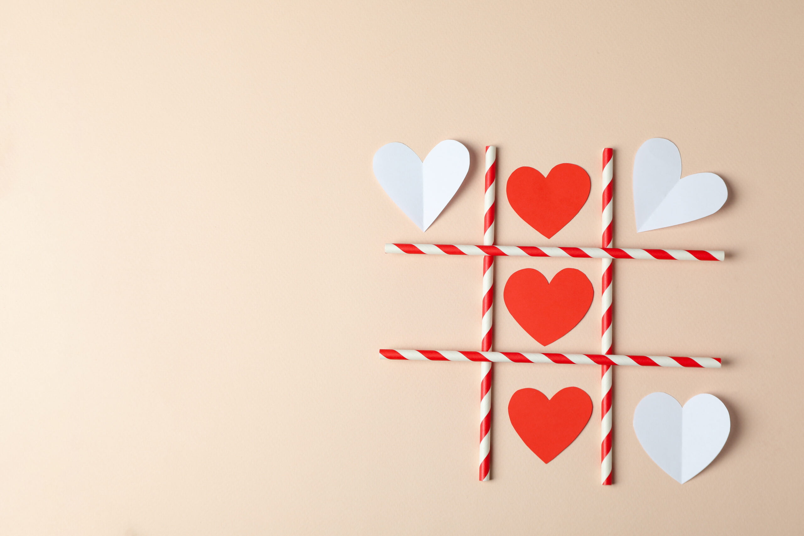 Valentine's Day concept with tic tac toe on beige background